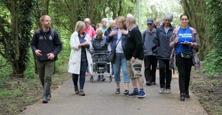 Group on Mirrlees Fields guided walk, with walkers of different ages on a path.