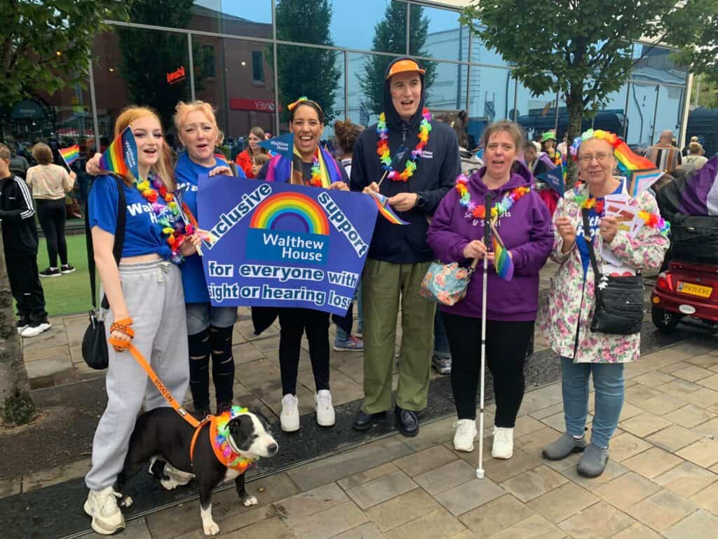 Group of people wearing Pride rainbow accessories