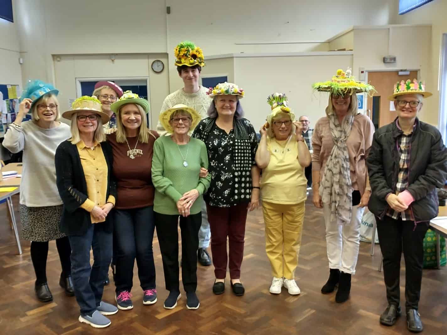 Group of people wearing decorated hats, Friends of Walthew House event.