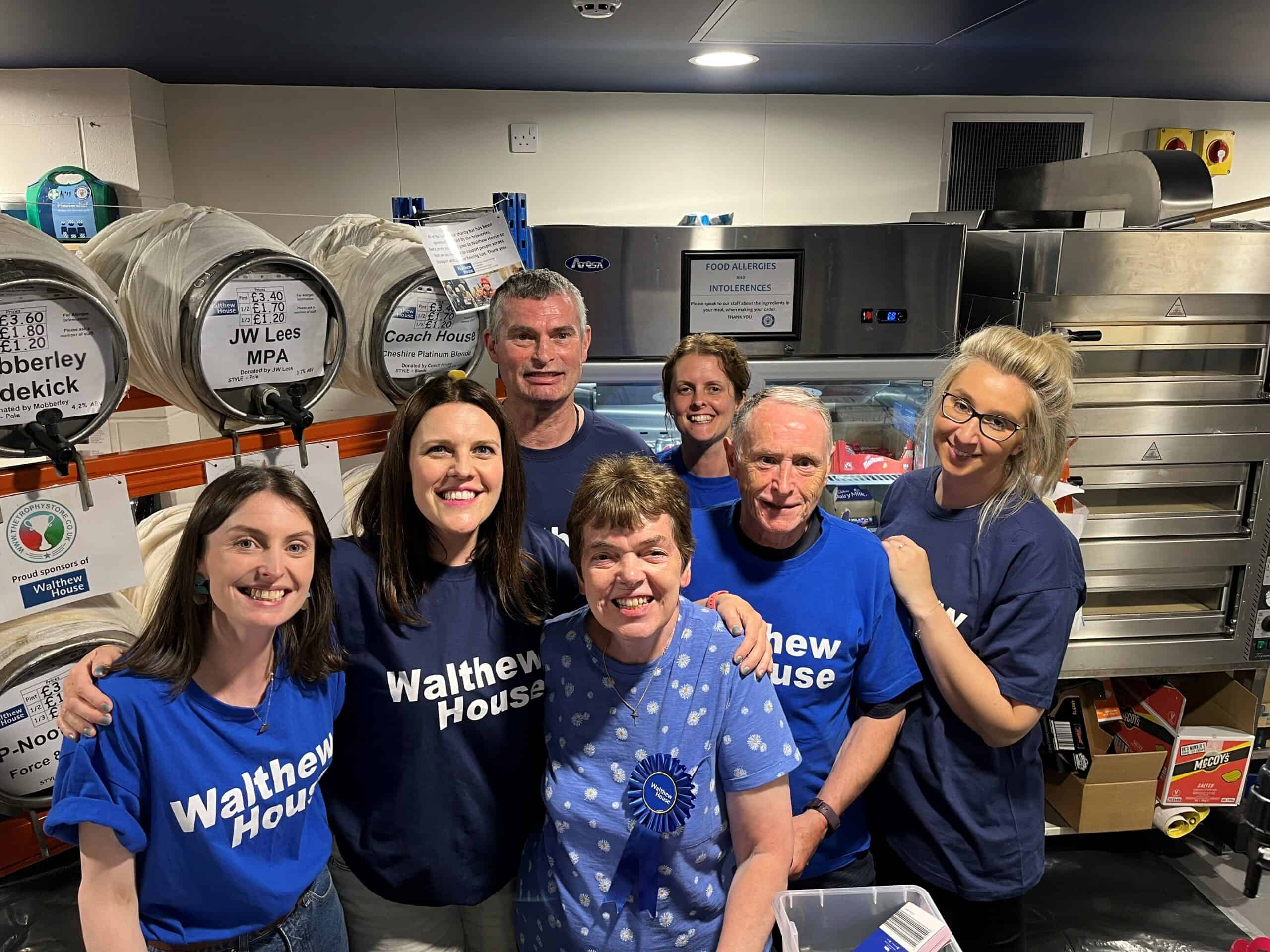Volunteers at the Stockport Beer & Cider Festival 2023, wearing "Walthew House" shirts.