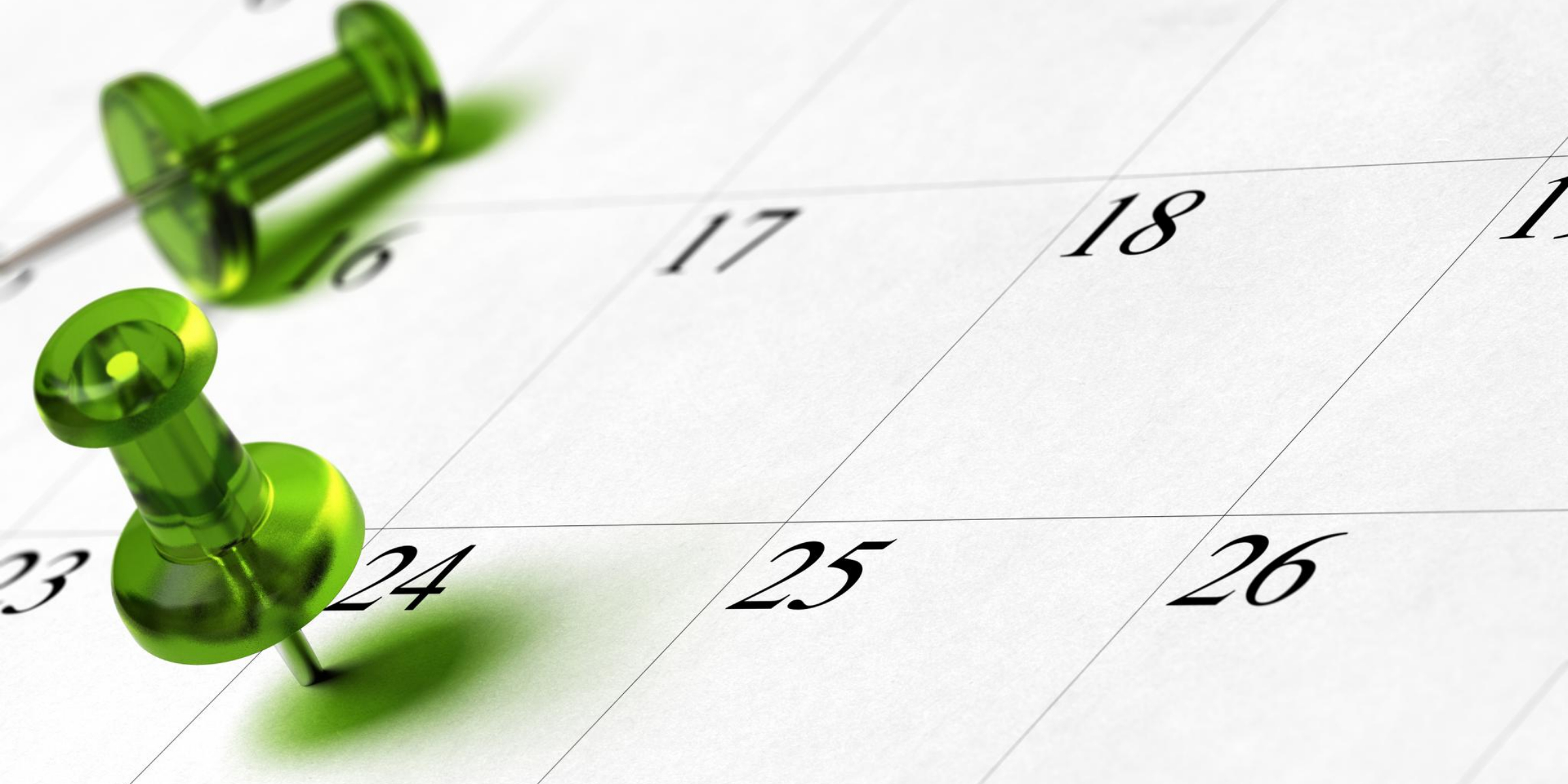 Green push pins on a calendar marking the 16th and 24th. Room hire.