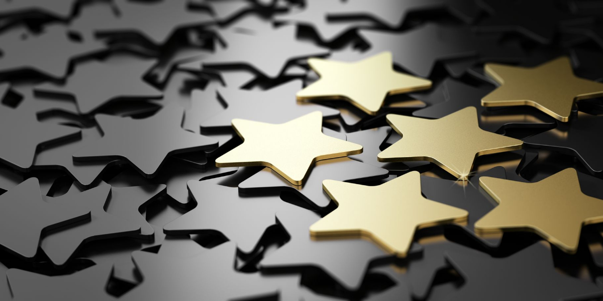 Gold stars stand out against a background of black stars.