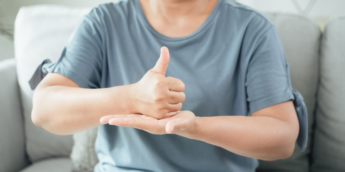 Person using sign language, thumb up on palm. Training and raising awareness of sign language.