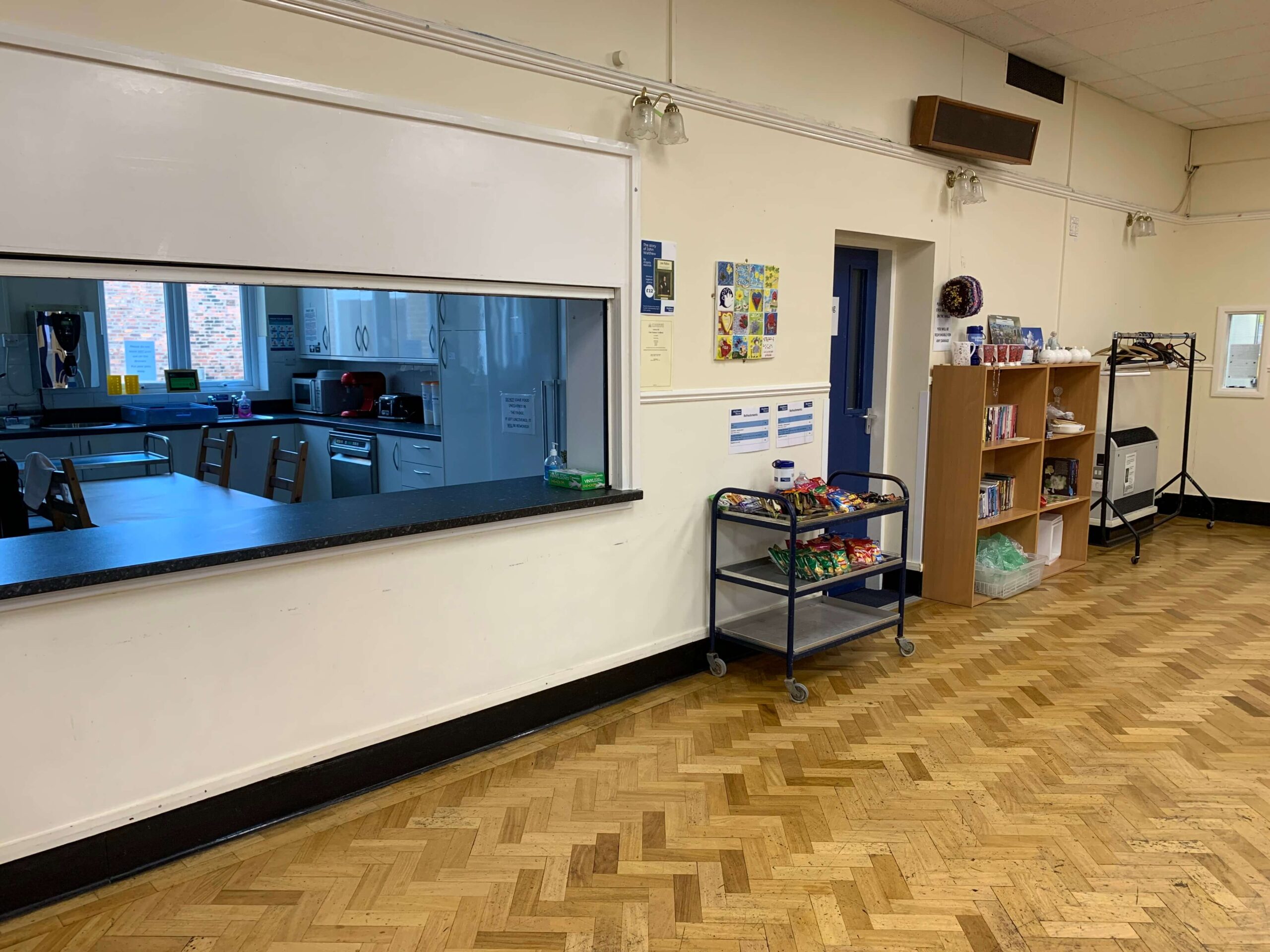 Community hall kitchen and snack area with herringbone wood floor