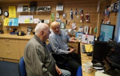 Older man talking to a customer in a store setting, Summer 2019 Newsletter.