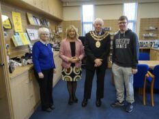 Four people at Walthew House during a mayoral visit pose for a photo.