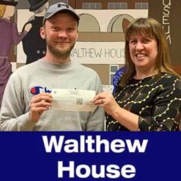 Man and woman holding cheque